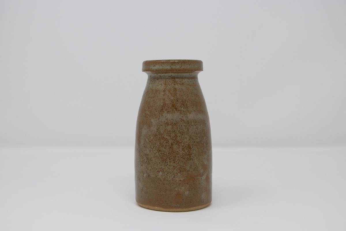 A small, brown speckled vase.