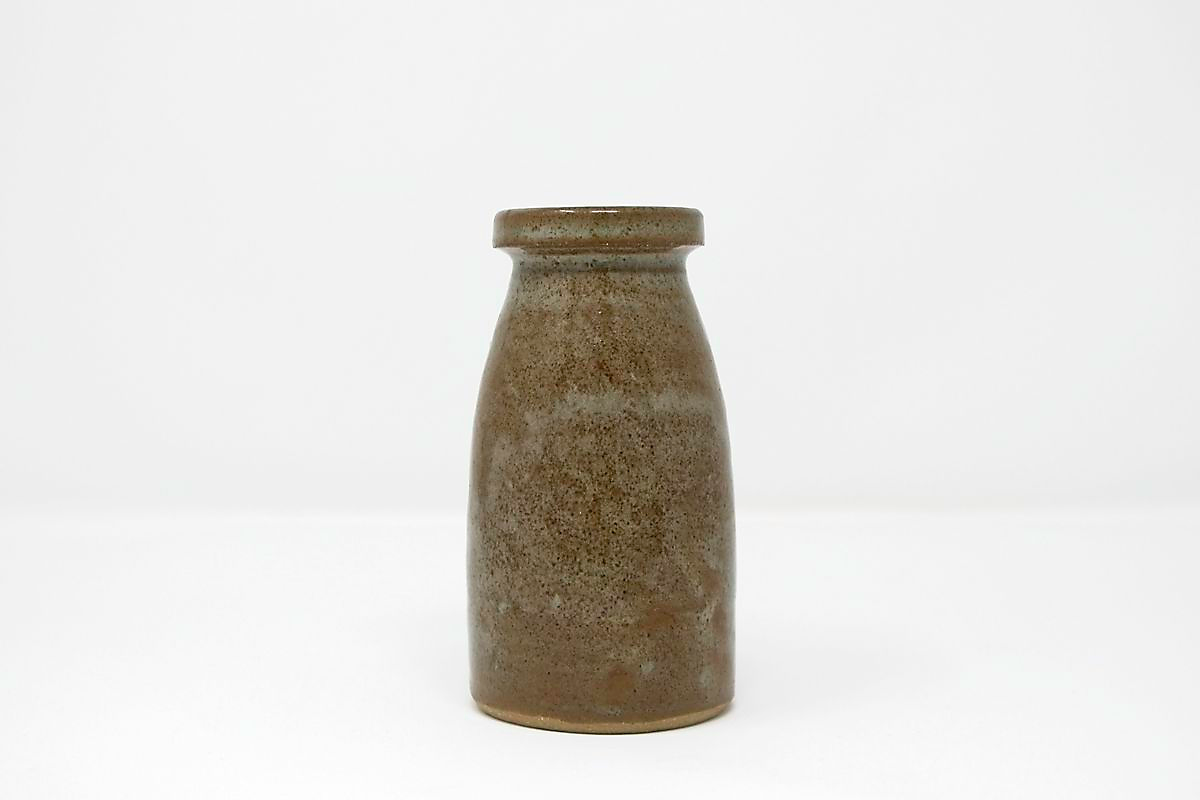 A small, brown speckled vase.