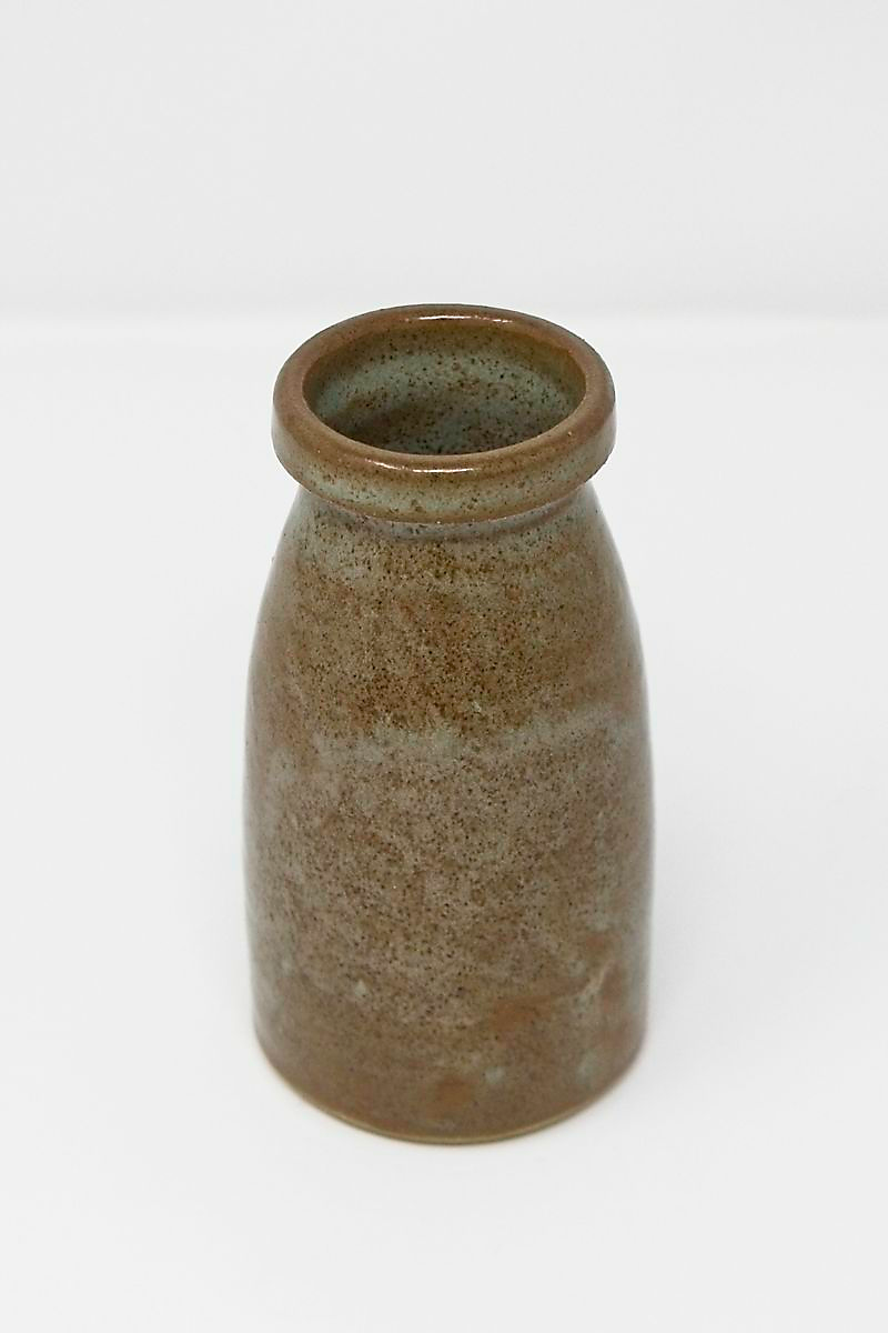 A small, brown speckled vase.